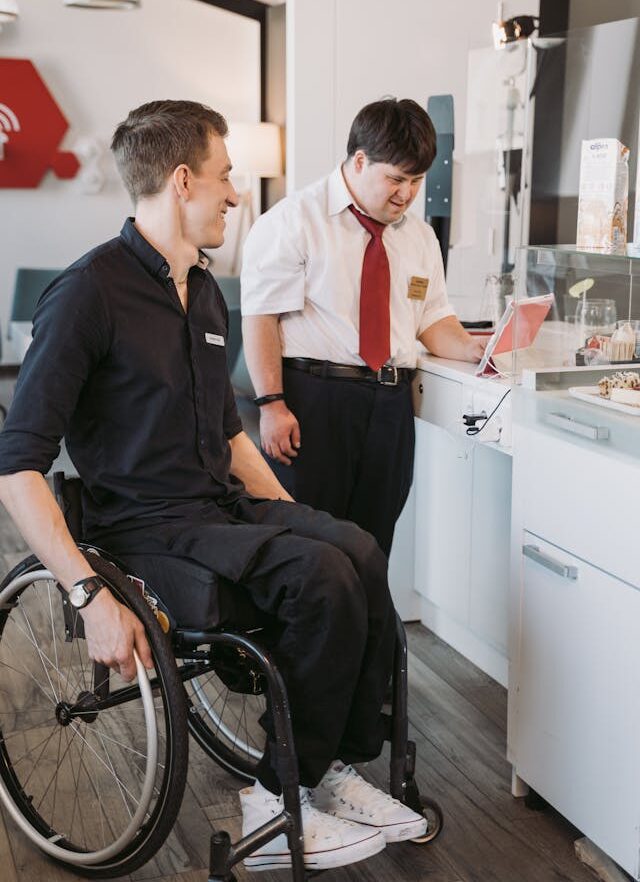 Support worker assisting a participant in a Supported Independent Living home
