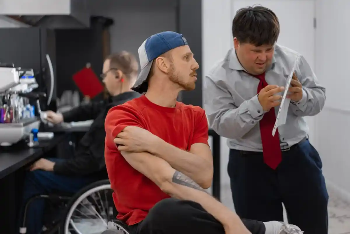 A support worker helping a person review paperwork about disability support eligibility